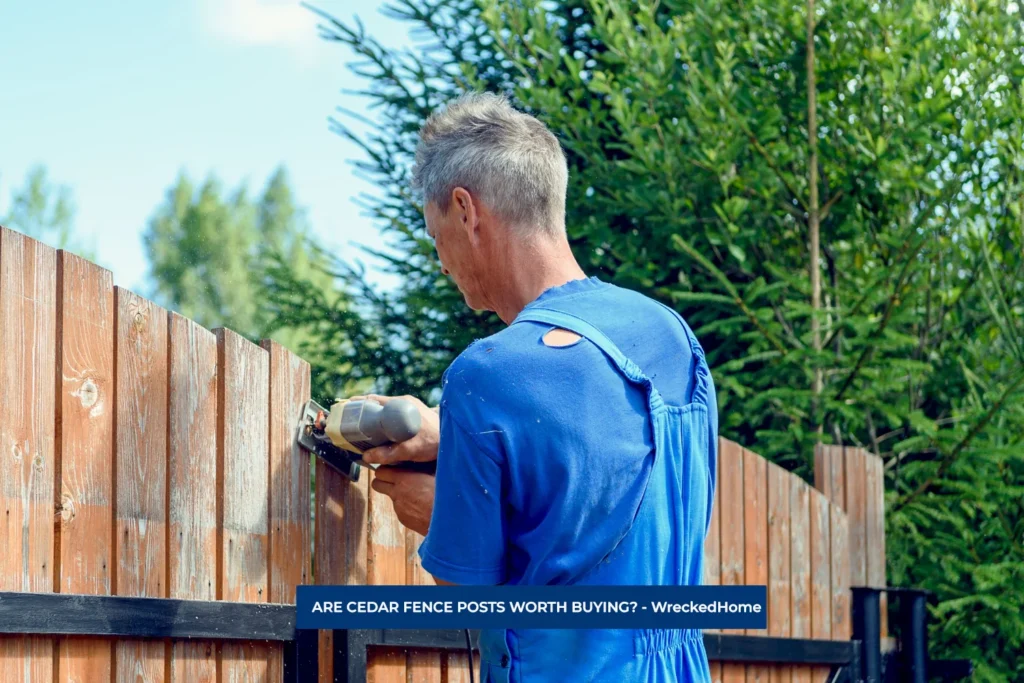 Man Working on CEDAR FENCE POSTS