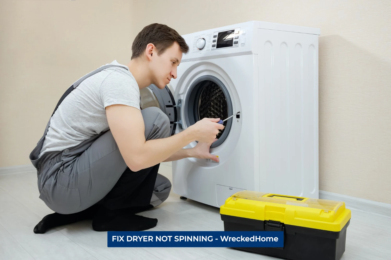 WORKER FIXING DRYER NOT SPINNING