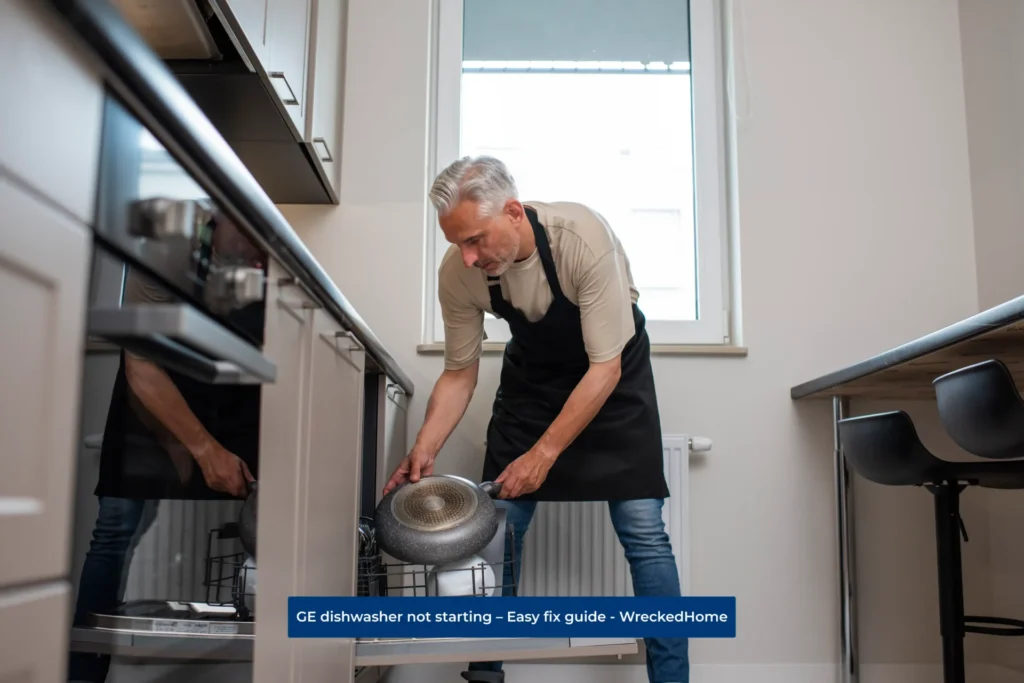 Worker taking dishes out of GE dishwasher