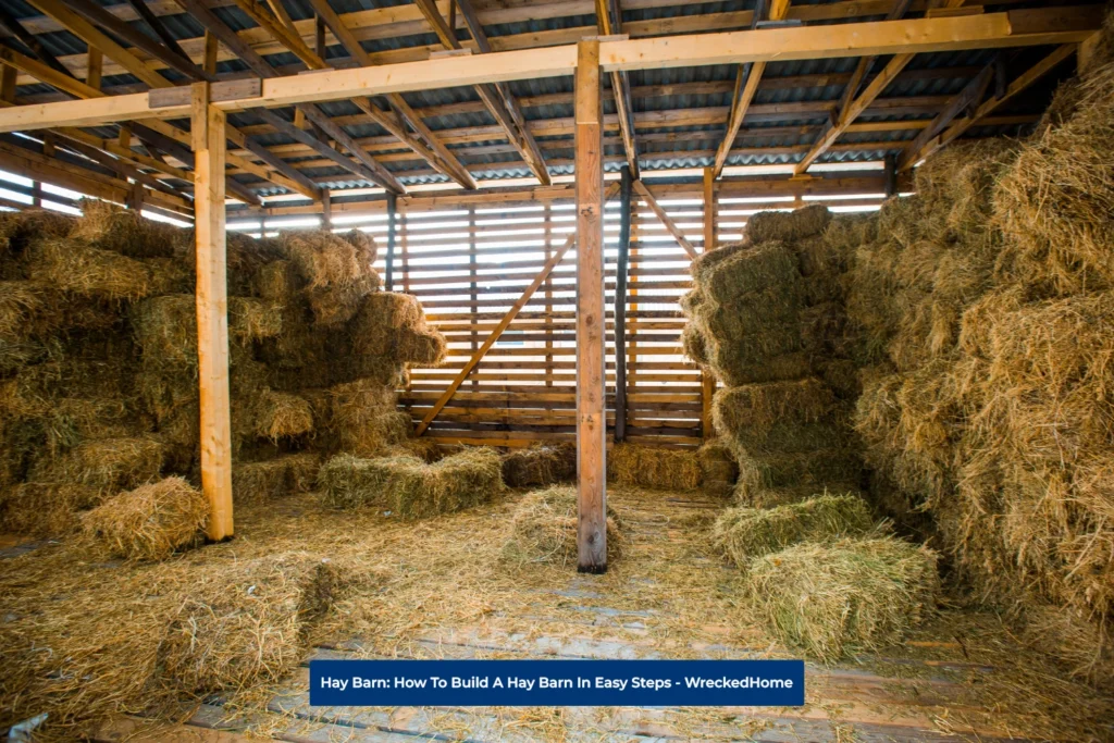 Inside a large Hay Barn, build with wood, Filled with Hay.