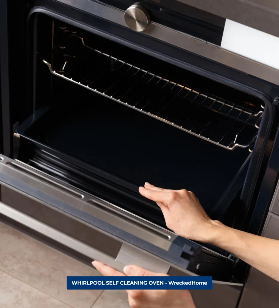 WOMAN TAKING OUT WHIRLPOOL SELF CLEANING OVEN TRAY.