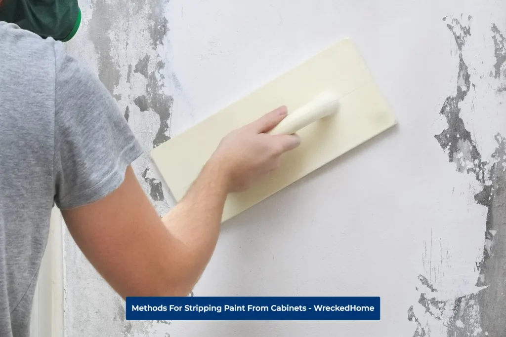 Man Striping Wall Paint With Platering Trowel