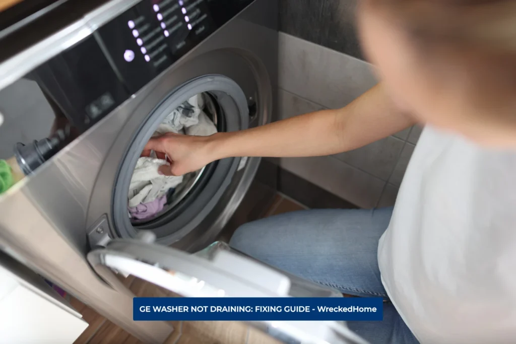 WOMAN TAKING CLOTHES OUT OF GE WASHER WHICH IS NOT DRAINING.