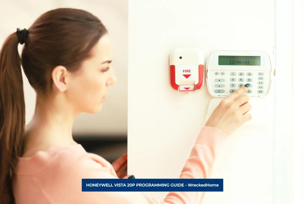 WOMAN DOING HONEYWELL VISTA 20P PROGRAMMING MOUNTED ON A WALL.