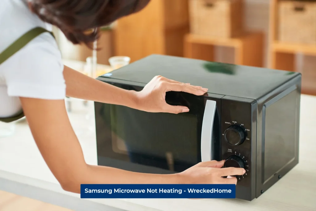 Woman turning the temperature knob on Microwave because she sees her Samsung Microwave not Heating.